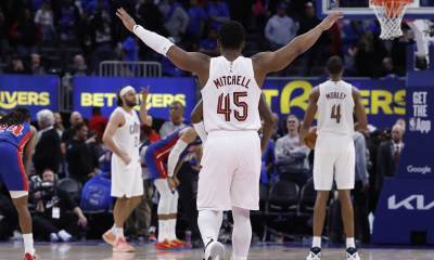 Cavaliers guard Donovan Mitchell (45) celebrates in overtime against the Detroit Pistons during game five of the second round of the 2026 NBA Playoffs at Little Caesars Arena with ESPN's Brian Windhorst in the background