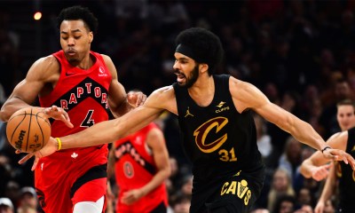 Raptors forward Scottie Barnes (4) goes for a loose ball against Cleveland Cavaliers center Jarrett Allen (31) during the second half of game seven in the first round of the 2026 NBA Playoffs at Rocket Arena with Nuggets' Nikola Jokic in the background