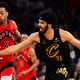 Raptors forward Scottie Barnes (4) goes for a loose ball against Cleveland Cavaliers center Jarrett Allen (31) during the second half of game seven in the first round of the 2026 NBA Playoffs at Rocket Arena with Nuggets' Nikola Jokic in the background
