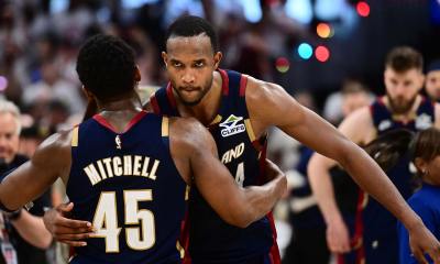 Cavs guard Donovan Mitchell (45) hugs center Evan Mobley (4)