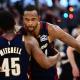 Cavs guard Donovan Mitchell (45) hugs center Evan Mobley (4)
