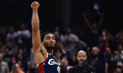 Cavs guard Donovan Mitchell (45) shoots a three-point basket