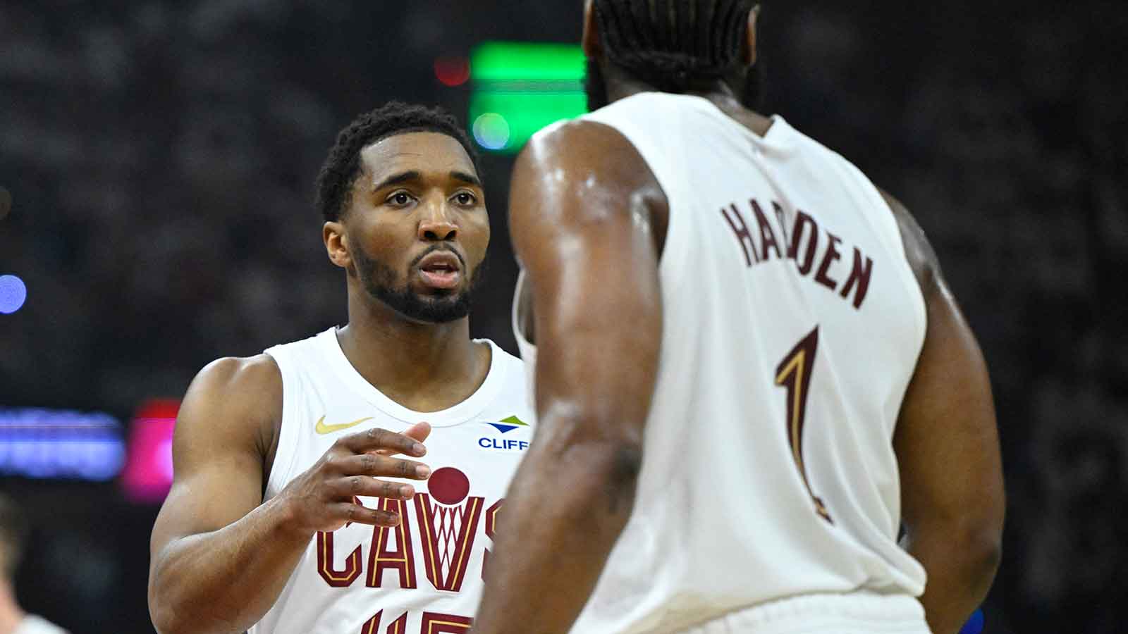 Cavs guard Donovan Mitchell (45) talks to guard James Harden