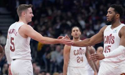 Cleveland Cavaliers guard Sam Merrill (5) and guard Donovan Mitchell (45) celebrate a basket against the Toronto Raptors at Scotiabank Arena.