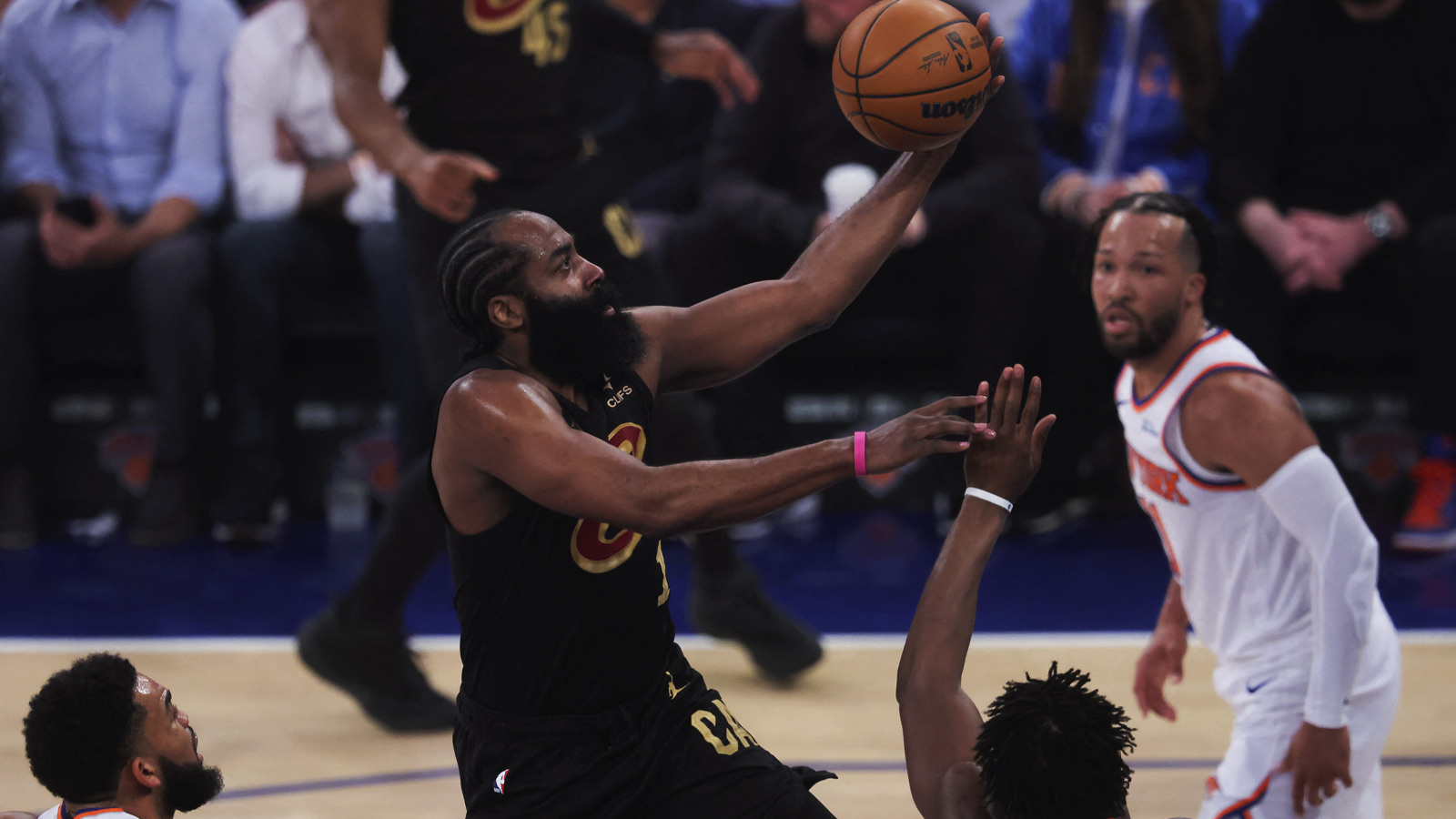 Cleveland Cavaliers guard James Harden (1) drives to the basket against New York Knicks center Karl-Anthony Towns (32), forward Og Anunoby (8), and guard Jalen Brunson (11) during the first quarter of game one of the eastern conference finals during the 2026 NBA playoffs at Madison Square Garden.