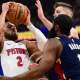 Detroit Pistons guard Cade Cunningham (2) drives to the basket against Cleveland Cavaliers guard James Harden (1) and forward Dean Wade (32) during the first half of game four in the second round of the 2026 NBA Playoffs at Rocket Arena.