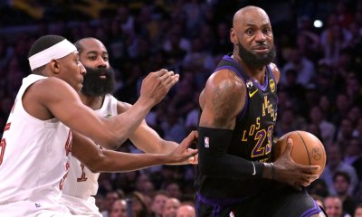 Los Angeles Lakers forward LeBron James (23) is defended by Cleveland Cavaliers guard James Harden (1) and forward Nae'qwan Tomlin (35) in the first half at Crypto.com Arena.