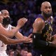 Los Angeles Lakers forward LeBron James (23) is defended by Cleveland Cavaliers guard James Harden (1) and forward Nae'qwan Tomlin (35) in the first half at Crypto.com Arena.