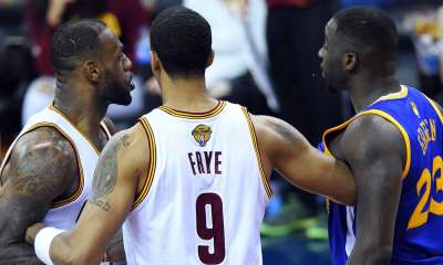 Cleveland Cavaliers forward LeBron James (23) and Golden State Warriors forward Draymond Green (23) are separated by Cleveland Cavaliers forward Channing Frye (9) during the fourth quarter in game four of the NBA Finals at Quicken Loans Arena.
