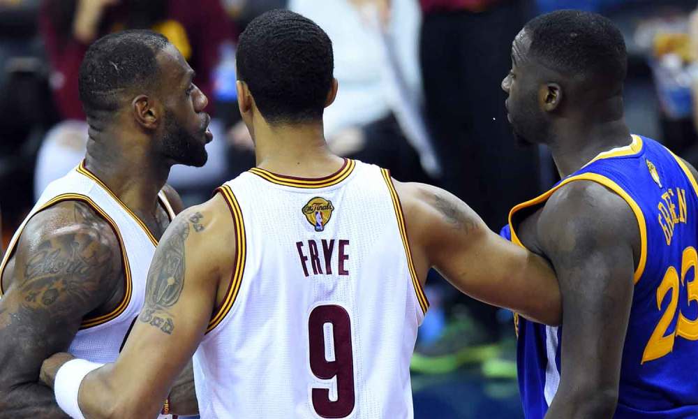 Cleveland Cavaliers forward LeBron James (23) and Golden State Warriors forward Draymond Green (23) are separated by Cleveland Cavaliers forward Channing Frye (9) during the fourth quarter in game four of the NBA Finals at Quicken Loans Arena.