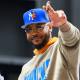 Knicks guard Carmelo Anthony waves to the crowd during the New York Knicks Championship Parade through the Canyon of Heroes with Cavs' Meleek Thomas in the background