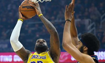 Los Angeles Lakers forward LeBron James (23) shoots beside Cleveland Cavaliers center Jarrett Allen (31) in the first quarter at Rocket Arena.