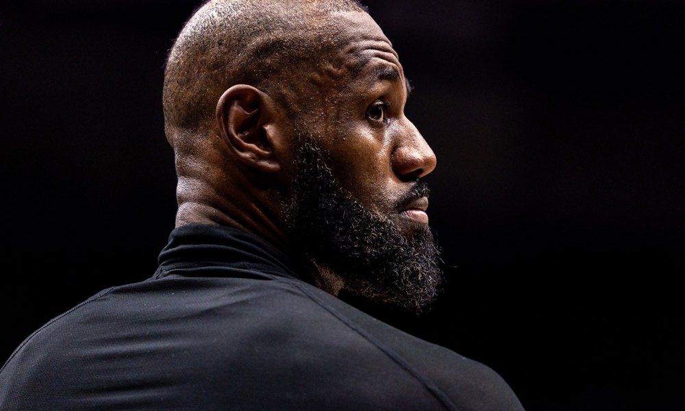Los Angeles Lakers forward LeBron James (23) looks on against the New Orleans Pelicans during the second half at Smoothie King Center with the Cavs logo in the background