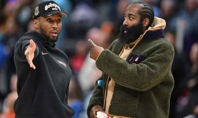 Cavs guard Donovan Mitchell (left) talks with teammate James Harden