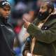 Cavs guard Donovan Mitchell (left) talks with teammate James Harden