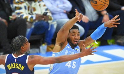 Cleveland Cavaliers guard Donovan Mitchell (45) throws a pass beside Denver Nuggets forward Peyton Watson (8) in the third quarter at Rocket Mortgage FieldHouse.
