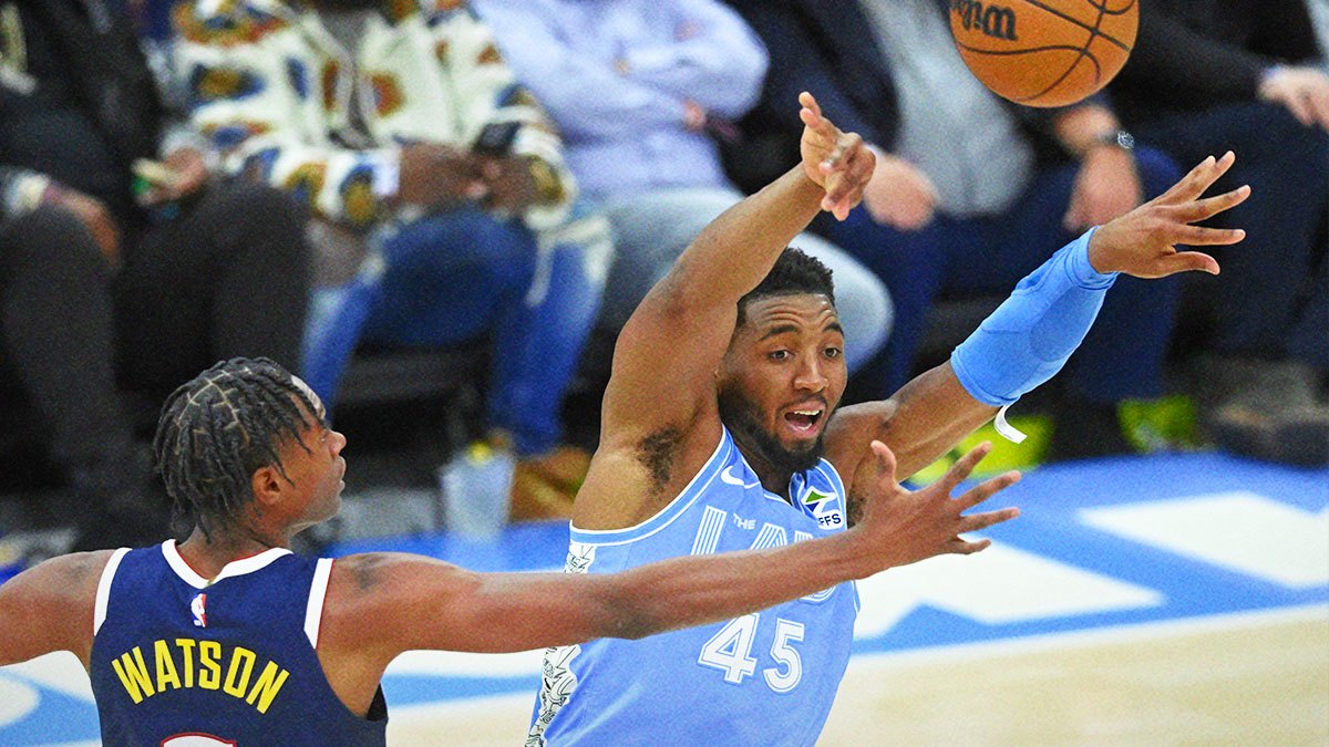 Cleveland Cavaliers guard Donovan Mitchell (45) throws a pass beside Denver Nuggets forward Peyton Watson (8) in the third quarter at Rocket Mortgage FieldHouse.